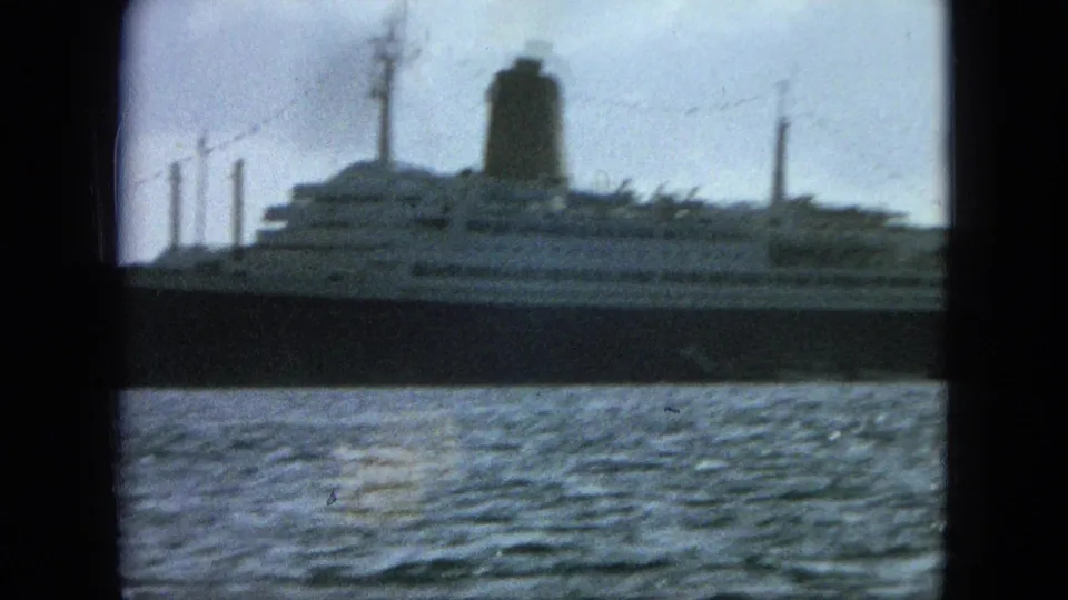 1964 8mm United States Virgin Islands maritime footage with a large passenger-style ship crossing the frame over rippled water.