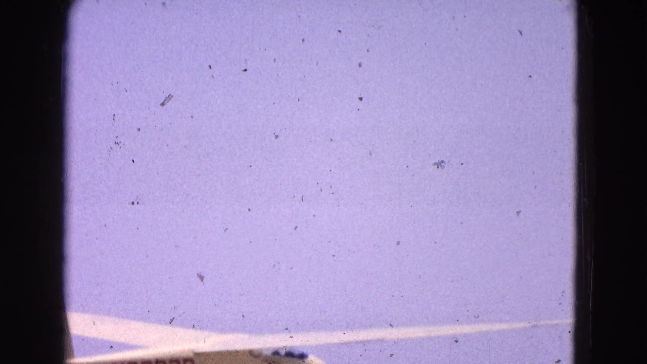 A cropped view of the glider wing and fuselage under a pale sky in 1964 Washington, DC area home-movie footage.