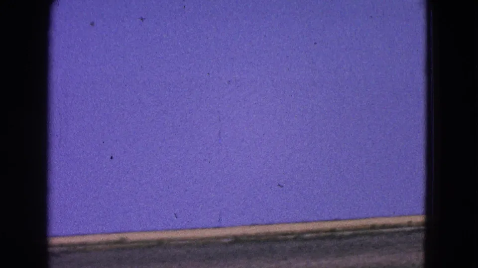 1964 Washington, DC 8mm frame showing a runway or flight-deck surface and open blue sky as the aircraft moves out of view.