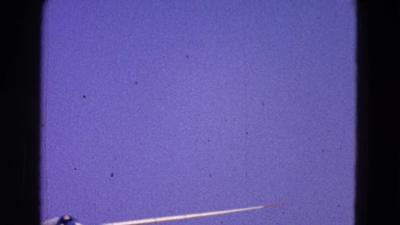 Partial glider wing and cockpit edge against a blue sky.