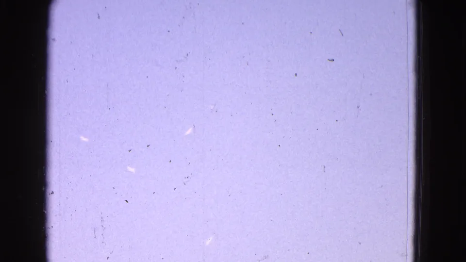 1964 Washington, DC home-movie frame after the airplane has largely left view, showing textured film and pale sky.