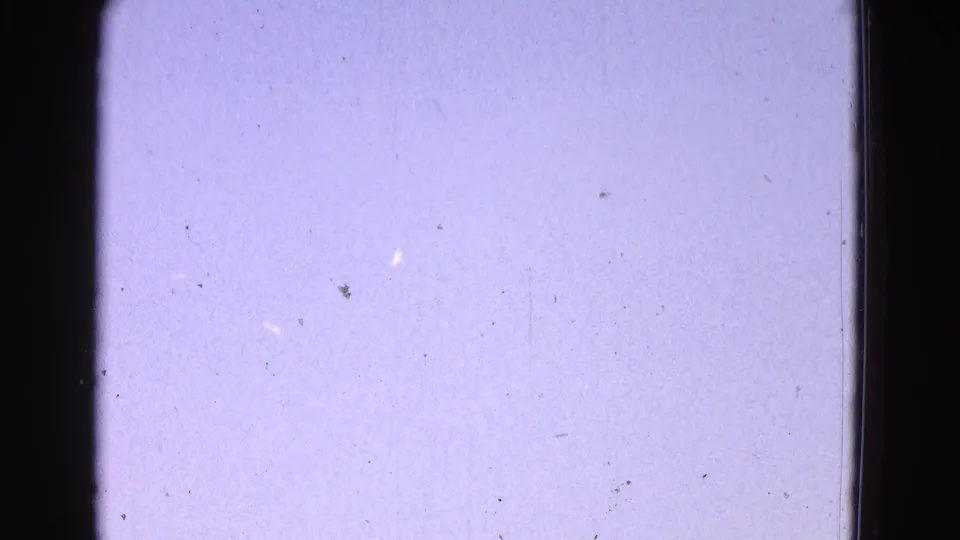 Final 1964 Washington, DC frame showing only pale sky, film grain, dust, and gate edges after the airplane exits.