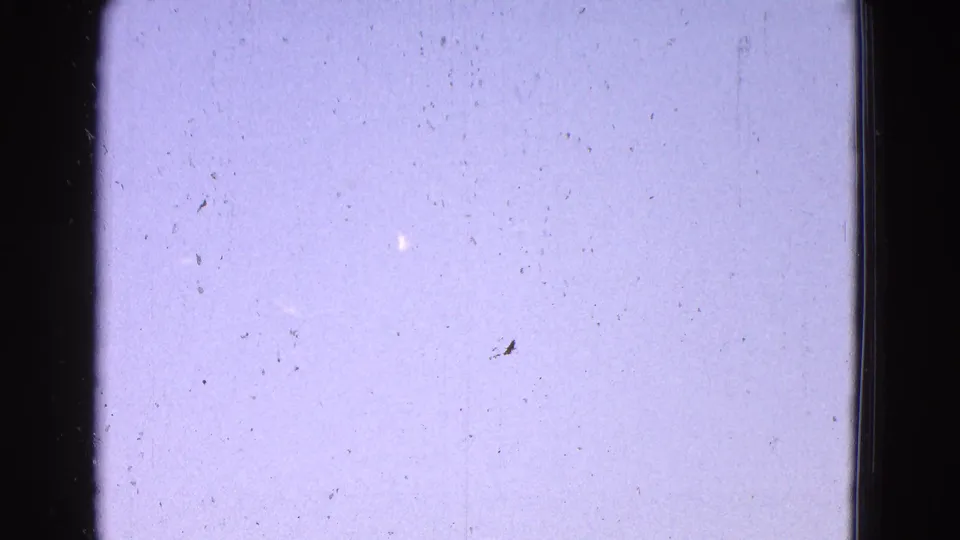 1964 Washington DC home-movie frame showing mostly bright sky, dark vertical framing, film dust, and no clearly visible aircraft.