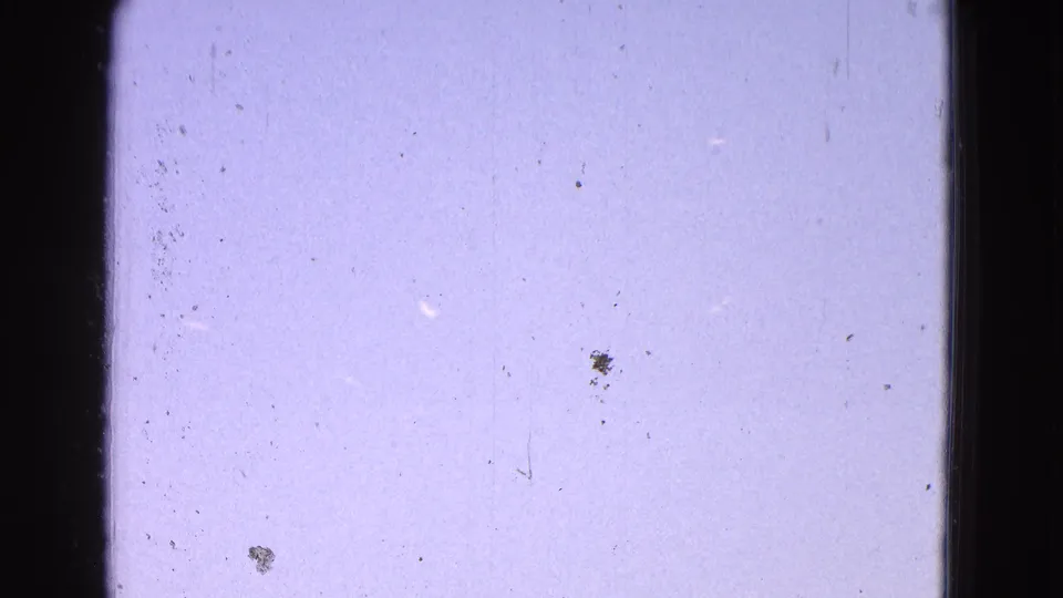 1964 Washington DC archival home-movie frame with open sky, dark vertical framing, dust specks, and no people or logos visible.