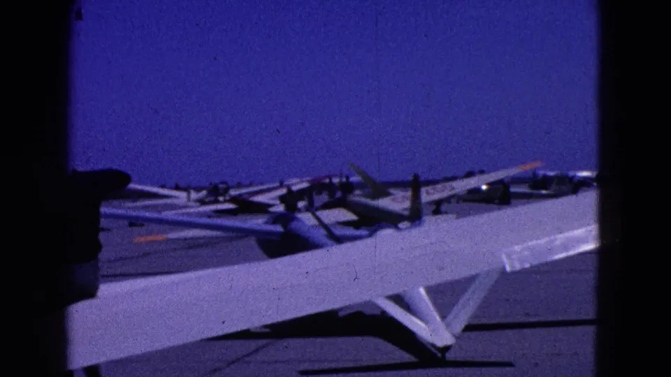 The final frame shifts to a darker blue-tinted view of the glider wing and cockpit area, with the aircraft silhouetted against sky.