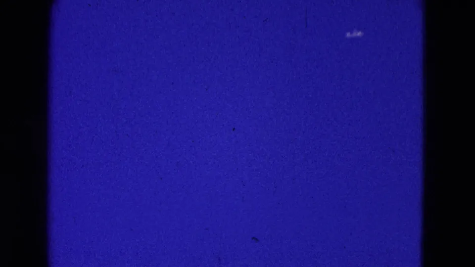 A small aircraft remains barely visible against the blue sky in this 1964 Washington, DC 8mm frame.