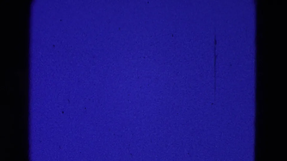 1964 Washington DC 8mm frame showing mostly deep blue sky or leader-like exposure with dust and film grain.