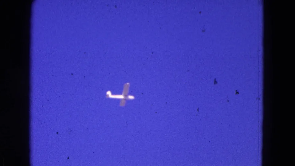 Final frame of the Washington, DC home movie shows the small plane isolated against a vivid shifted sky.