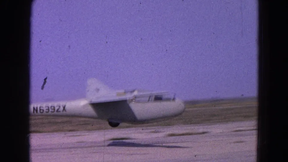 1964 8mm frame of glider N6392X airborne just above a Washington, DC area runway.