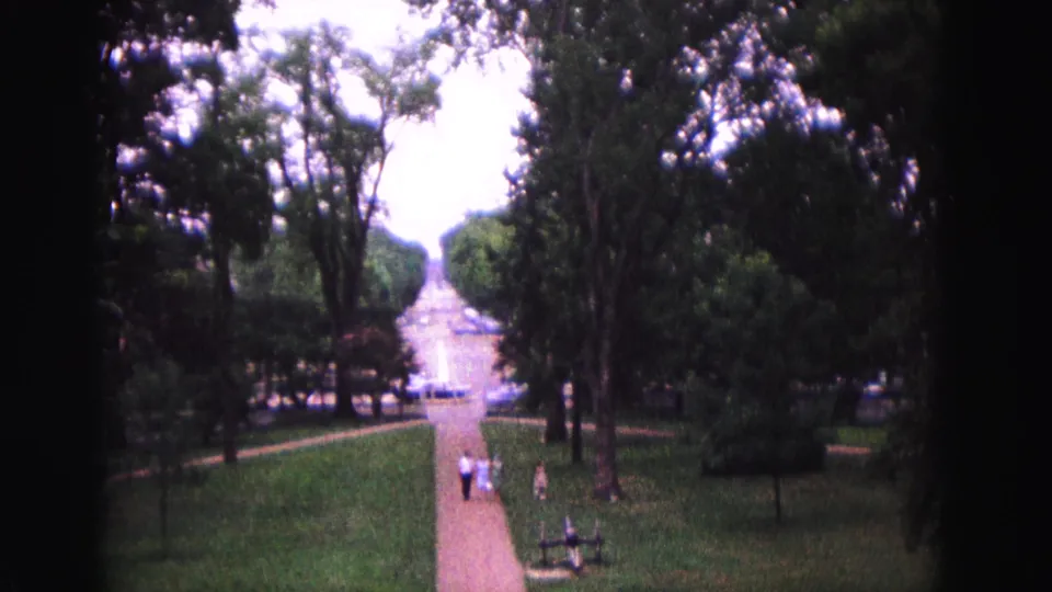The final frame shows a tree-lined Williamsburg walkway in 1964, with visitors moving through the landscaped grounds under soft 8mm exposure.