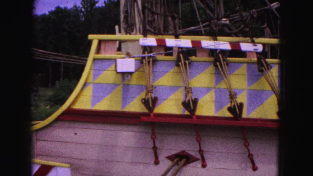 Colorful painted stern section with diamond pattern, red trim, and small decorative anchors.