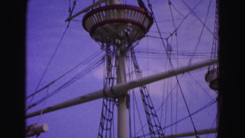 Final 1964 Williamsburg frame showing the ship's mast, crow's nest, rope ladders, rigging, and horizontal spar.