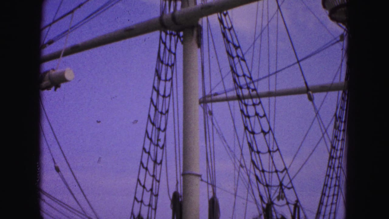 Rigging, mast sections and rope ladders cross the frame beside a dark vertical border.