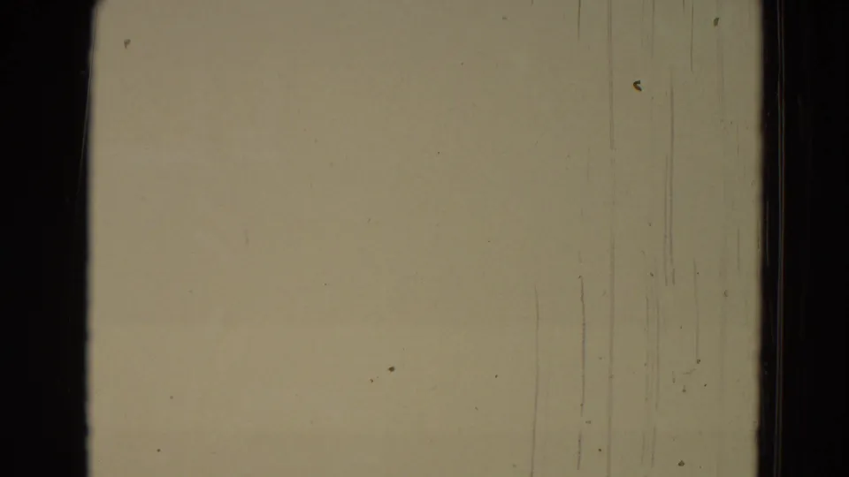 Overexposed beige frame from the 1965 8mm clip, showing film borders, scratches, and surface wear.