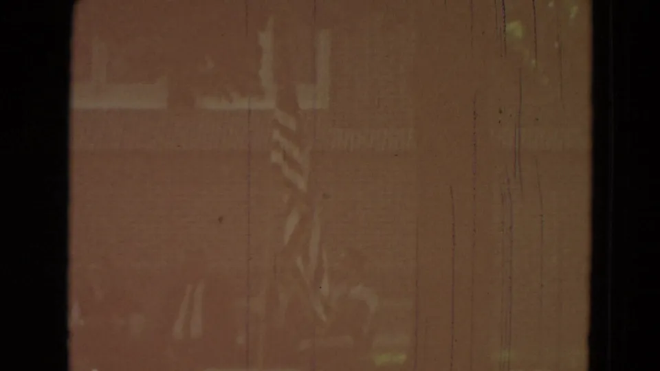 Faint 1965 Clarkson, Nebraska outdoor frame with a flag near a house-like background under warm faded color.