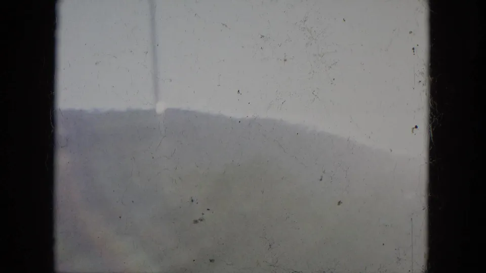1965 Louisville-area 8mm frame with hazy hills beyond a bridge railing under a pale sky.