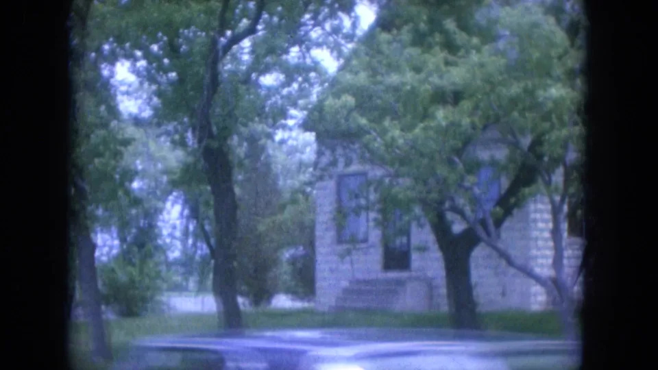 1965 Louisville frame with a stone house, front walkway, lawn, and leafy trees.