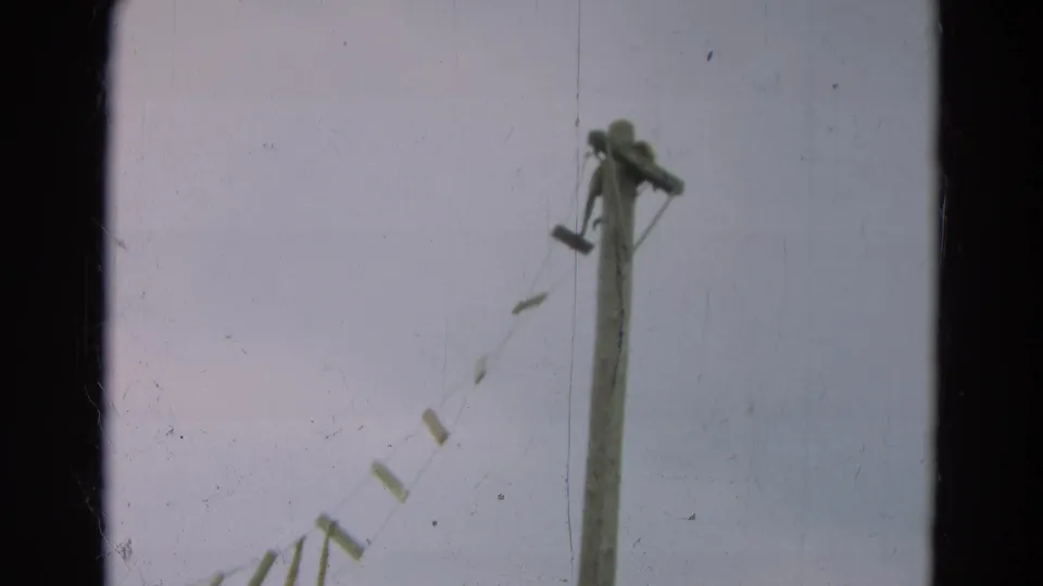 1965 Omaha 8mm frame with a tall wooden post and diagonal rope-supported bridge slats viewed from below.