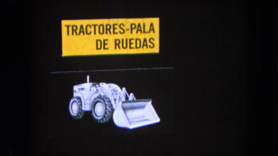 1965 Pueblo, Mexico frame with the Spanish wheel-loader tractor title and a white illustrated loader beneath it.