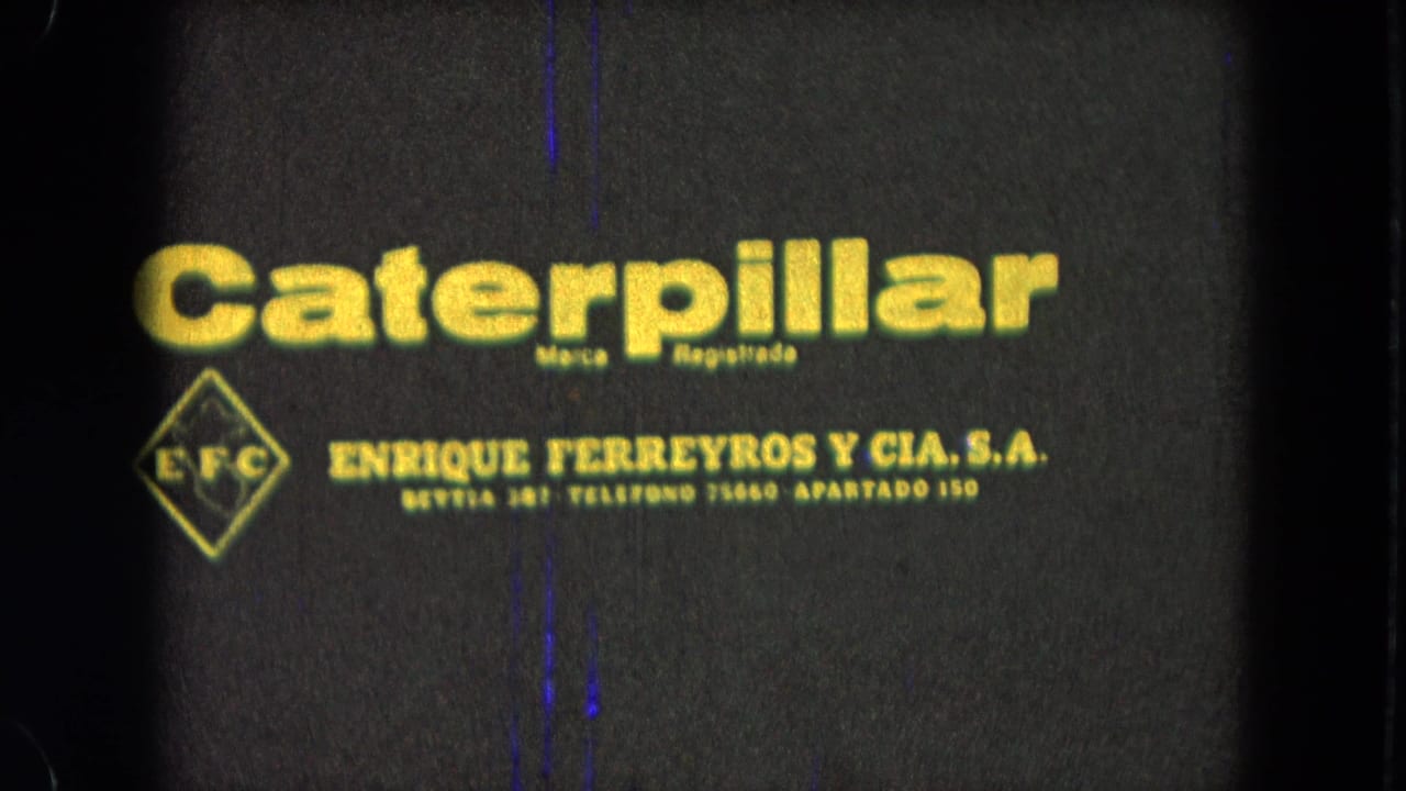 Caterpillar logo and Spanish company text with film scratches.