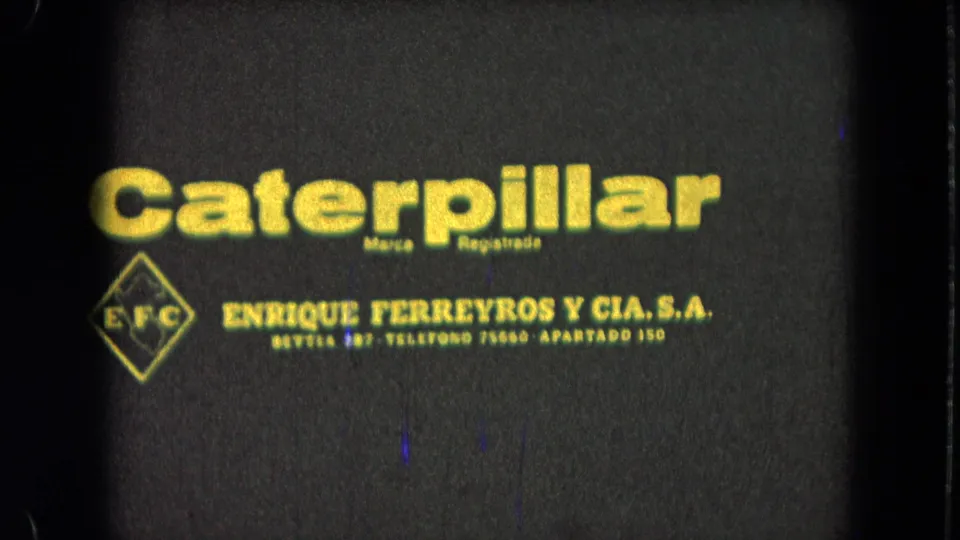1965 Pueblo, Mexico 8mm frame with soft-focus Caterpillar lettering, EFC mark, and Enrique Ferreyros y Cia. S.A. text.