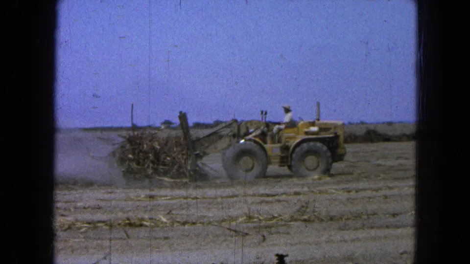 Near the end of the clip, the front-end loader keeps pushing debris across the dry Pueblo, Mexico field as dust hangs low.