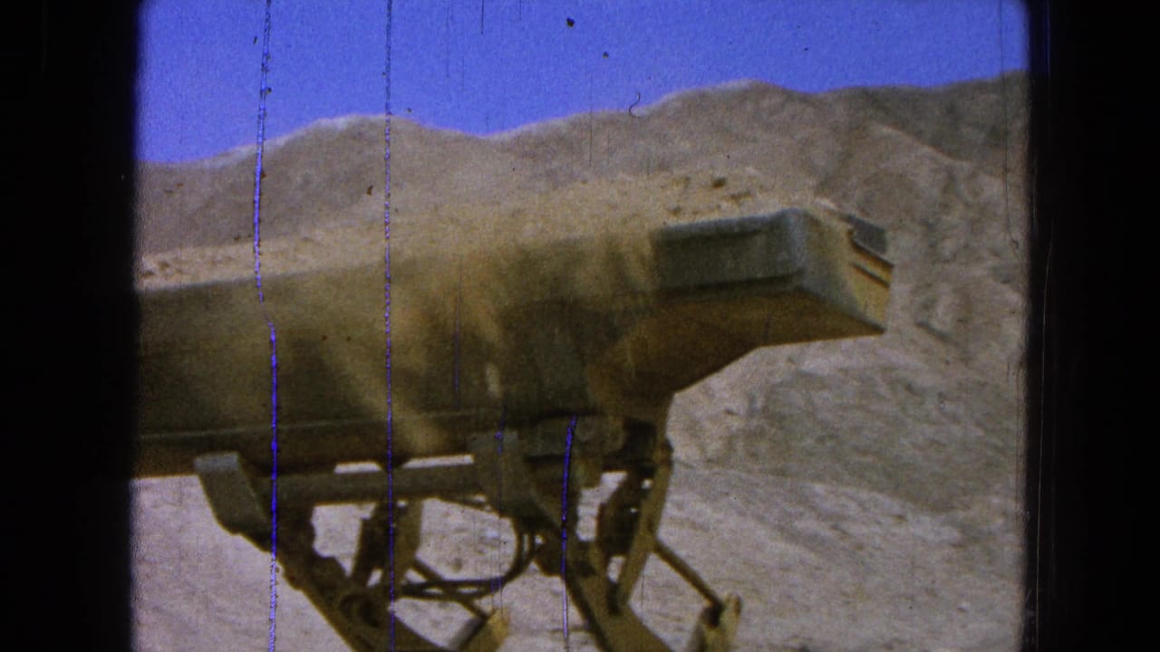 A dump truck bed dominates the 1965 Pueblo, Mexico quarry view, with dust drifting across excavated hills.