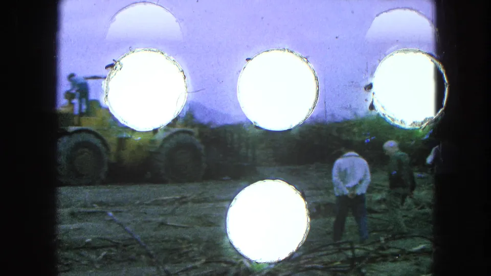1965 Pueblo, Mexico footage shows workers near heavy machinery, conveyors, and aggregate piles at an outdoor industrial site.