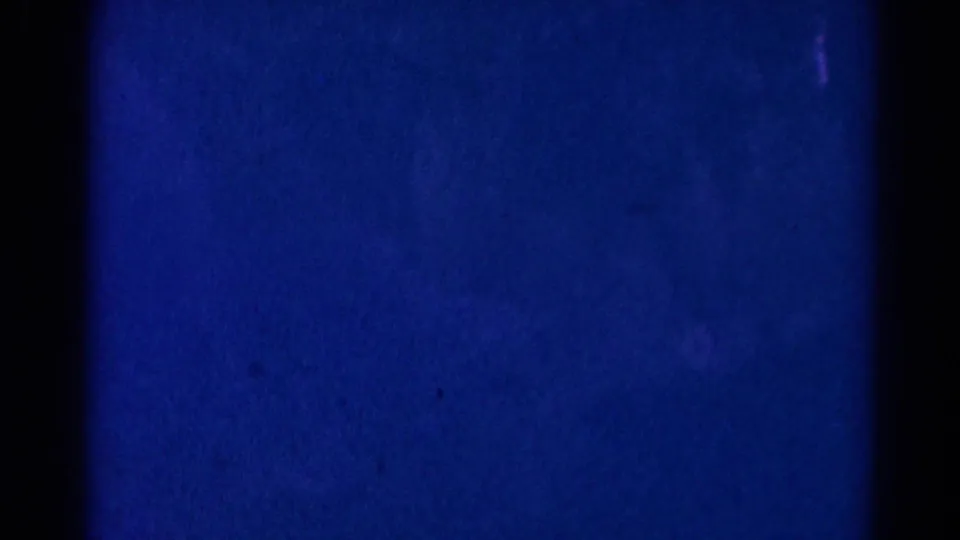 Blue and purple 8mm frame from the 1966 Danville church ceremony, with only faint interior shapes visible.