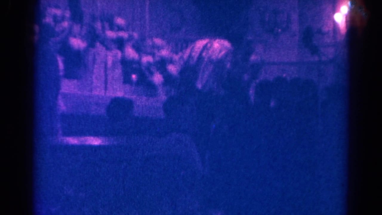 1966 Danville church service frame with worshippers seen from the pews and a priest conducting mass at the altar.