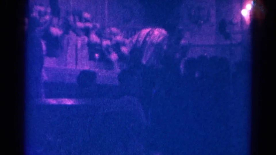 1966 Danville church service frame with worshippers seen from the pews and a priest conducting mass at the altar.