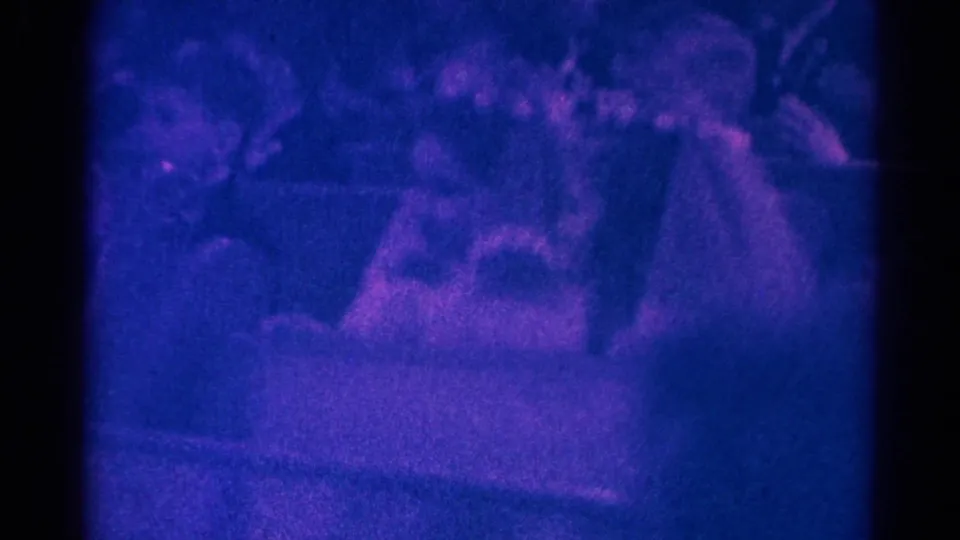 1966 Danville, Illinois frame showing two light-dressed girls or participants near pews during a church ceremony, with congregants behind them.