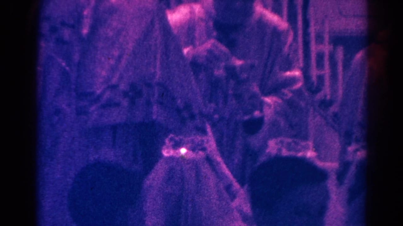 Priest in white vestments bends toward a communicant during a 1966 Danville church communion service.