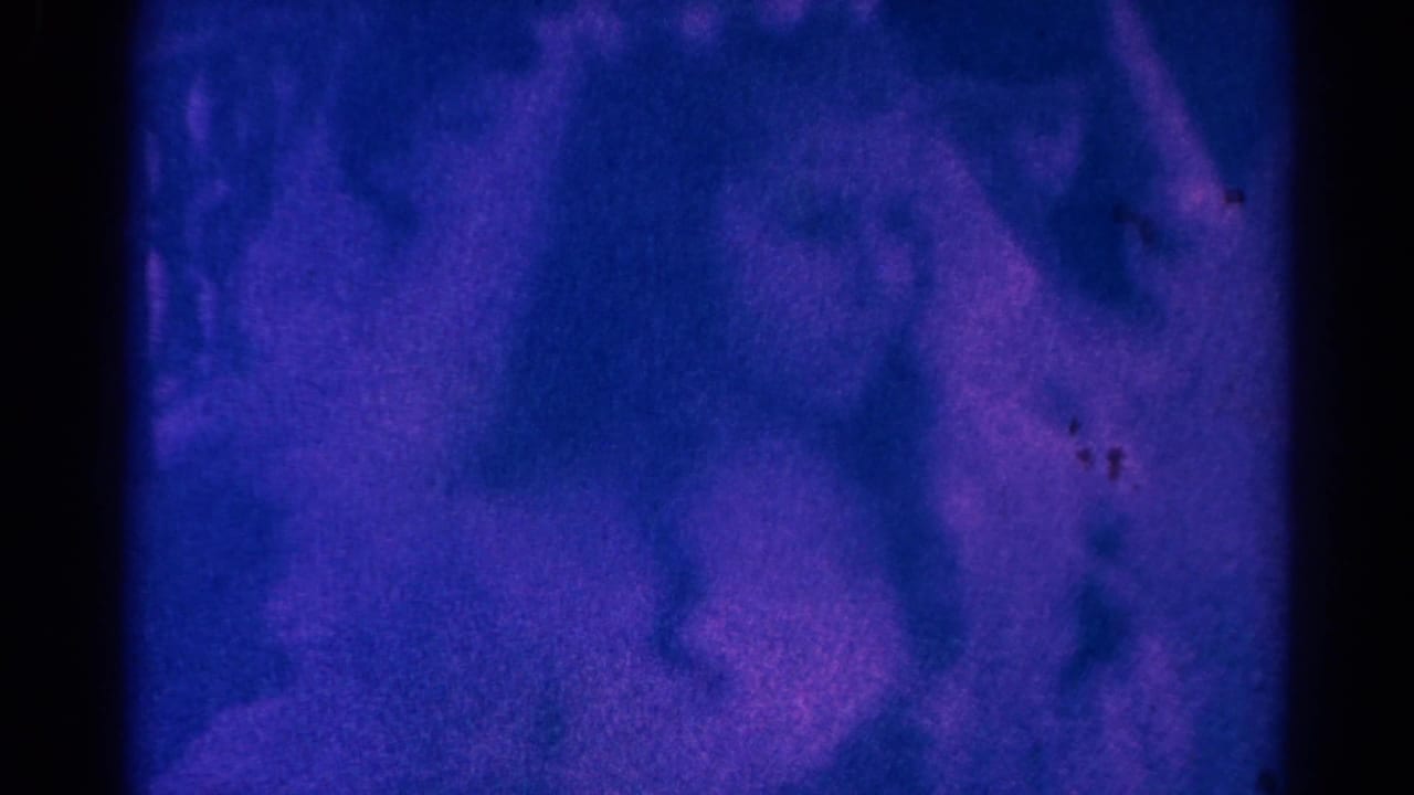 Heavily tinted 1966 home-movie frame from Danville, Illinois, with blurred figures in a church interior during a Communion ceremony.