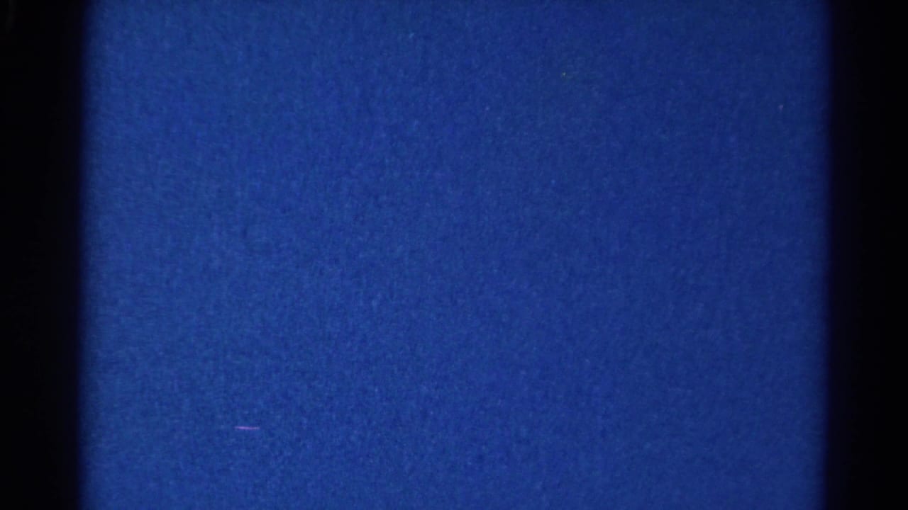Low-light 8mm frame from the 1966 Danville clip, dominated by blue exposure and a dark vertical band with no identifiable subjects.