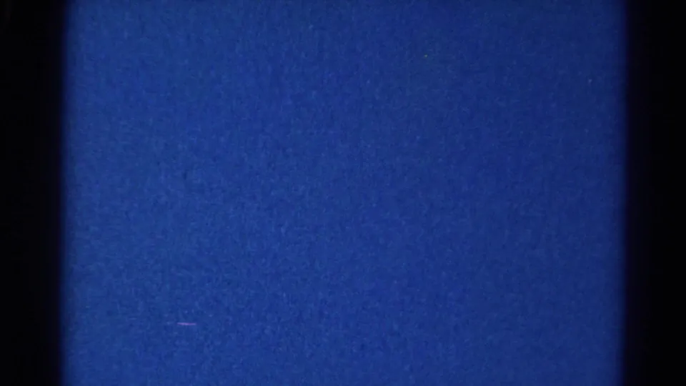Low-light 8mm frame from the 1966 Danville clip, dominated by blue exposure and a dark vertical band with no identifiable subjects.
