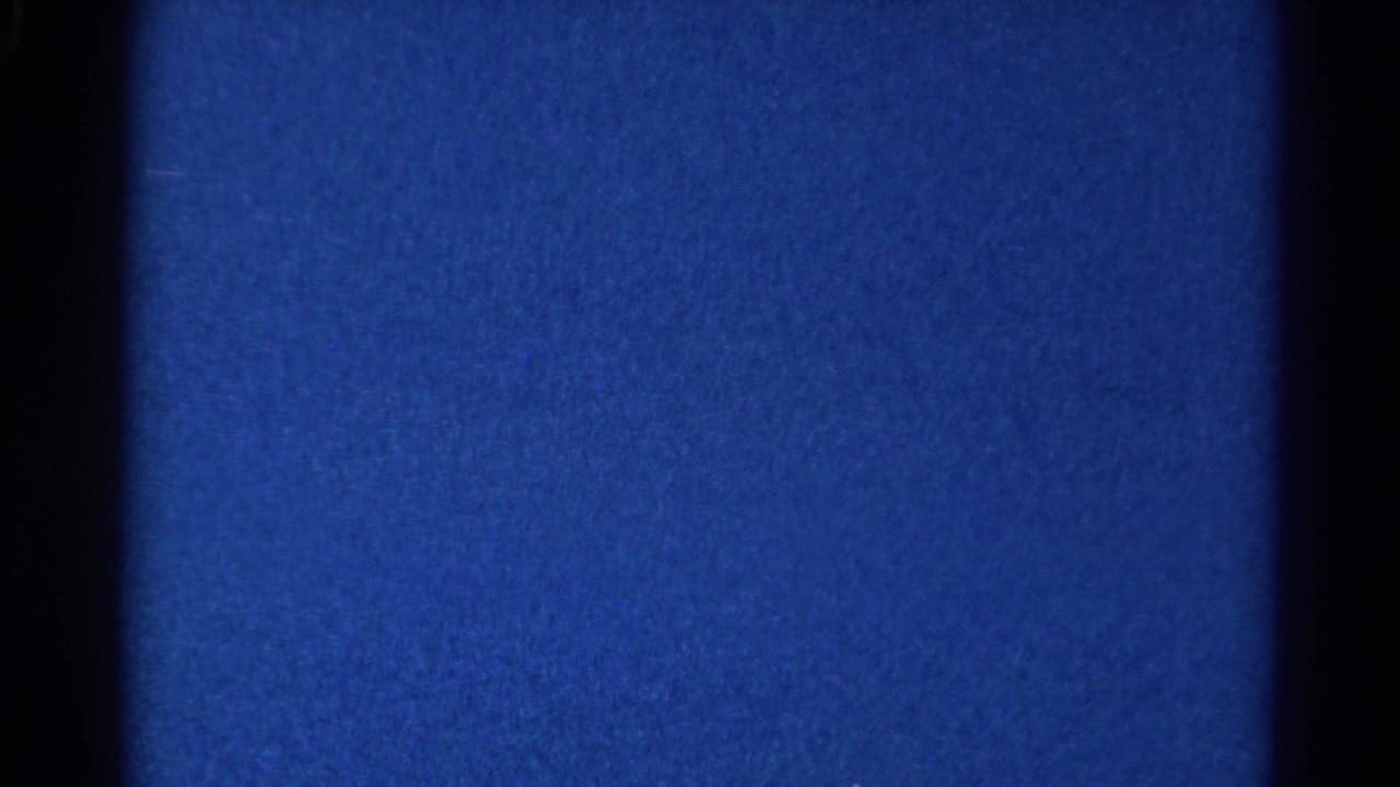 Blue film field with dark vertical borders and visible grain.