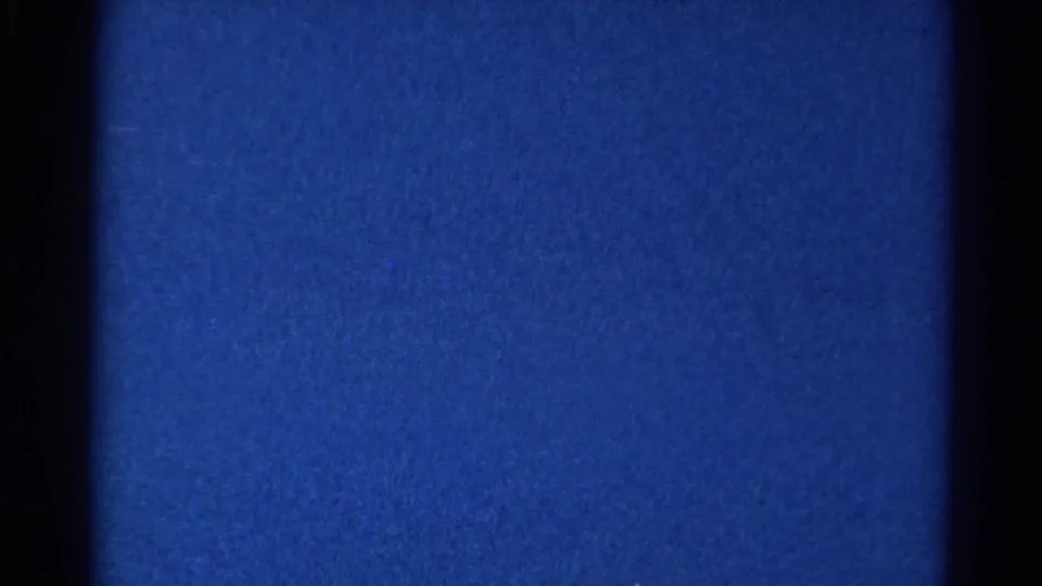 Blue 8mm film field from a 1966 Danville, Illinois home-movie clip, framed by dark borders with visible grain and faint dust.