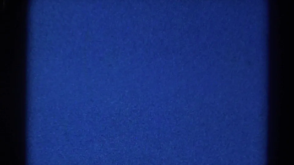 Steady blue 8mm frame from the 1966 Danville clip, showing dark gate edges, grain, and slight tonal variation.