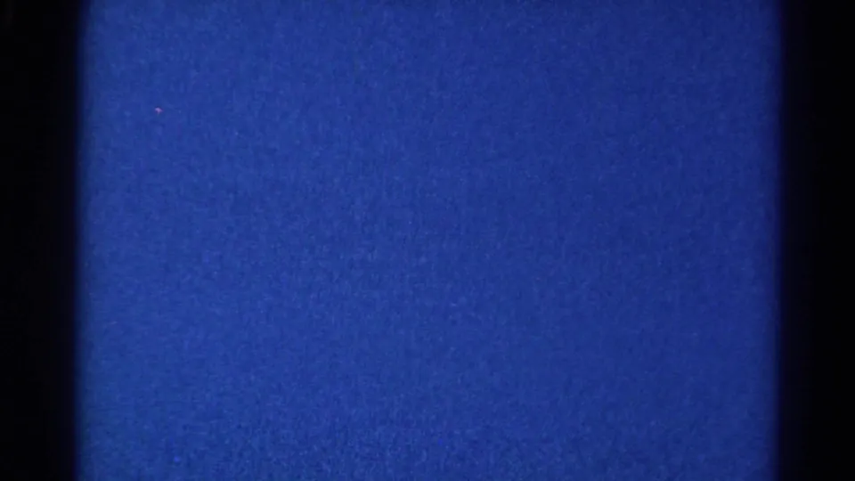 Blue 8mm frame near the end of the 1966 Danville clip, with dark gate borders, grain, and faint surface marks.