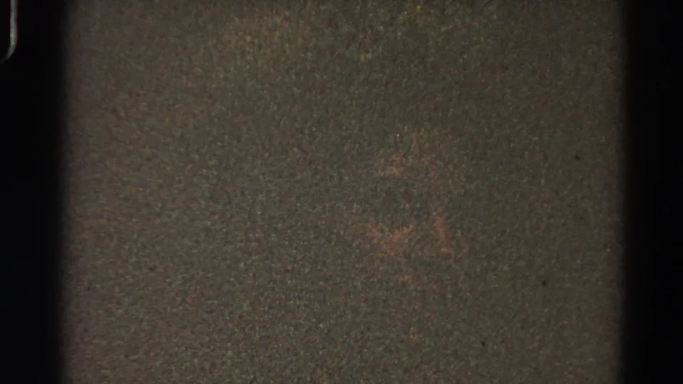 1966 Danville, Illinois 8mm home-movie frame showing darkness, heavy grain, gate edges, and a faint indistinct central mark.