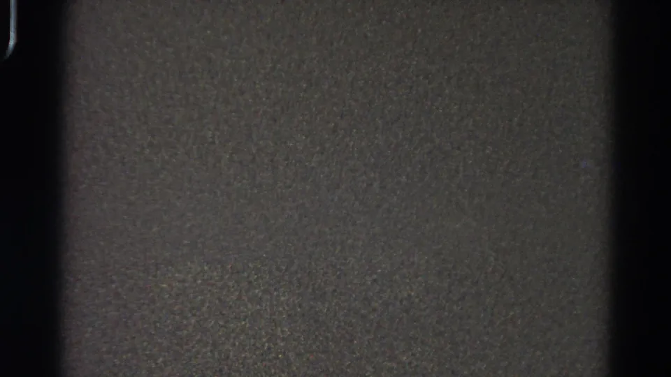 Low-light 1966 Danville 8mm frame with dark texture, grain, slight scratches, and no identifiable person or object.