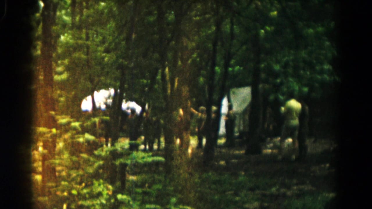 1966 8mm home-movie frame from near Hagerstown, Maryland showing people gathered among trees beside light-colored tents.