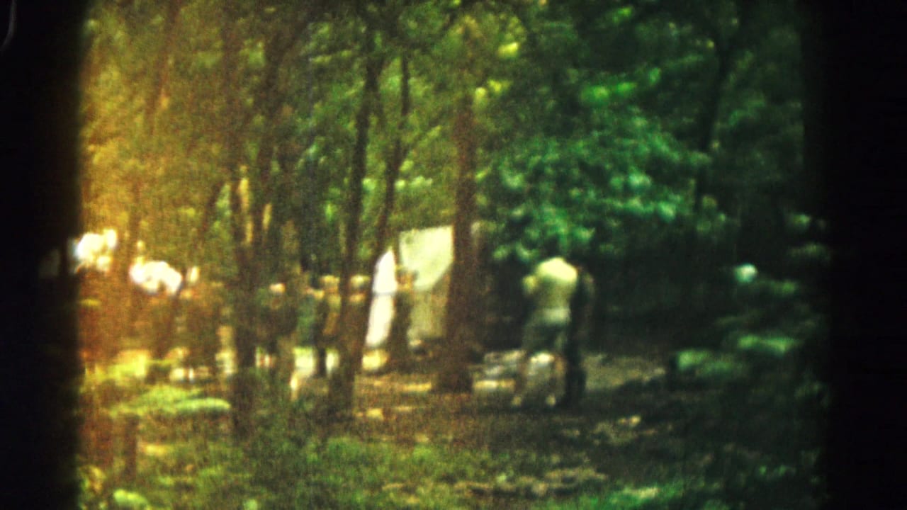 Wooded Hagerstown-area gathering in 1966 with adults near pale tents and camping gear under filtered sunlight.
