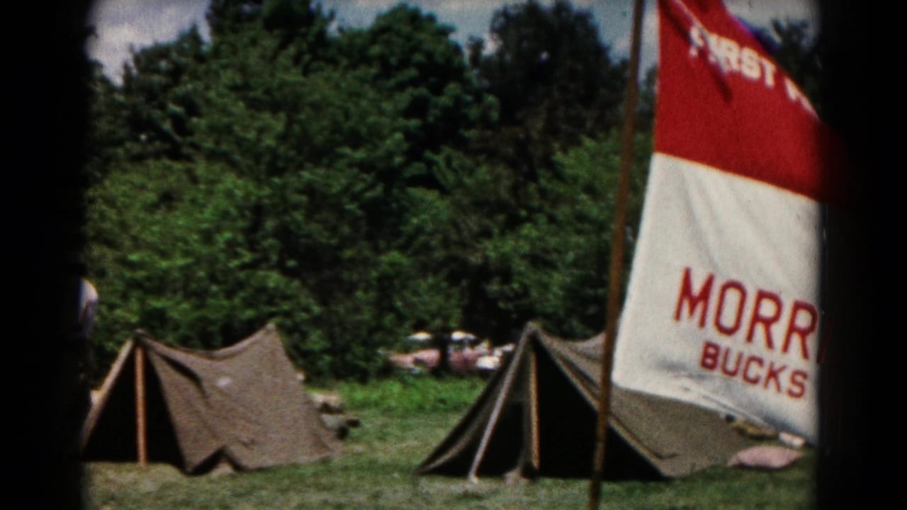 Campsite in Hagerstown, Maryland, with A-frame tents, trees, and a partially visible Morrisville church flag.