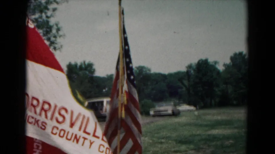Partial Morrisville troop banner and American flag are seen near parked cars in the 1966 Hagerstown camp scene.
