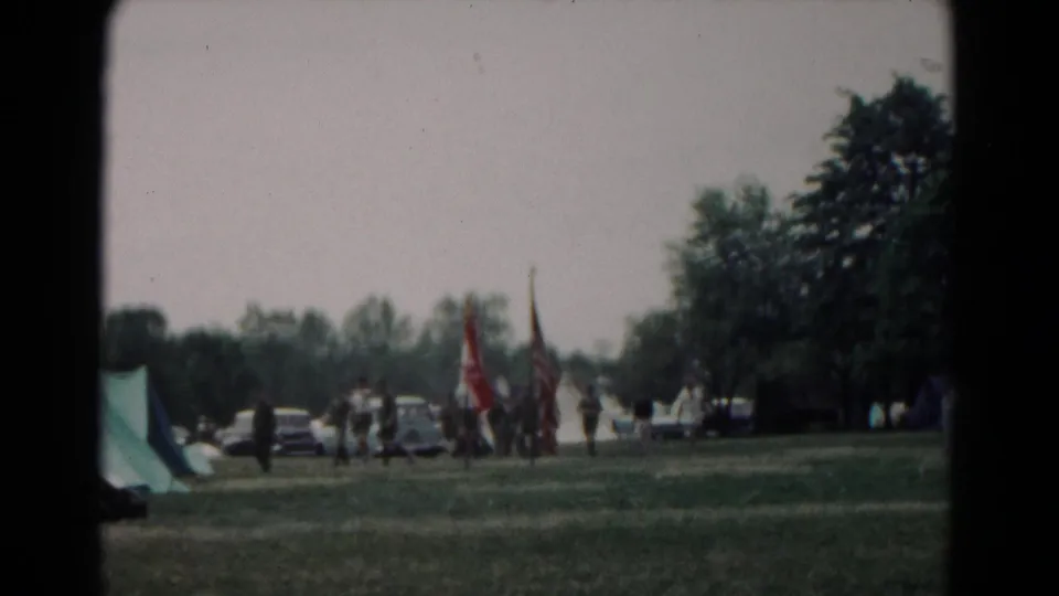 The final frame shows a distant group around flags in a 1966 Hagerstown park, with a tent, parked cars, grass, and trees in view.