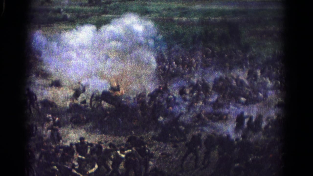 Crowded outdoor combat-like scene with smoke rising over people on rough ground.