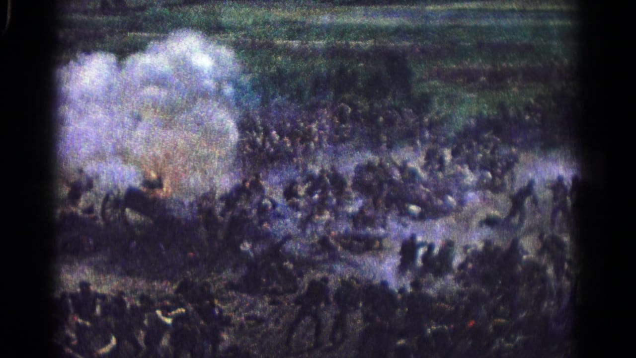 1966 Hagerstown home-movie frame with clustered figures, smoke clouds, and open field suggesting staged battlefield action.