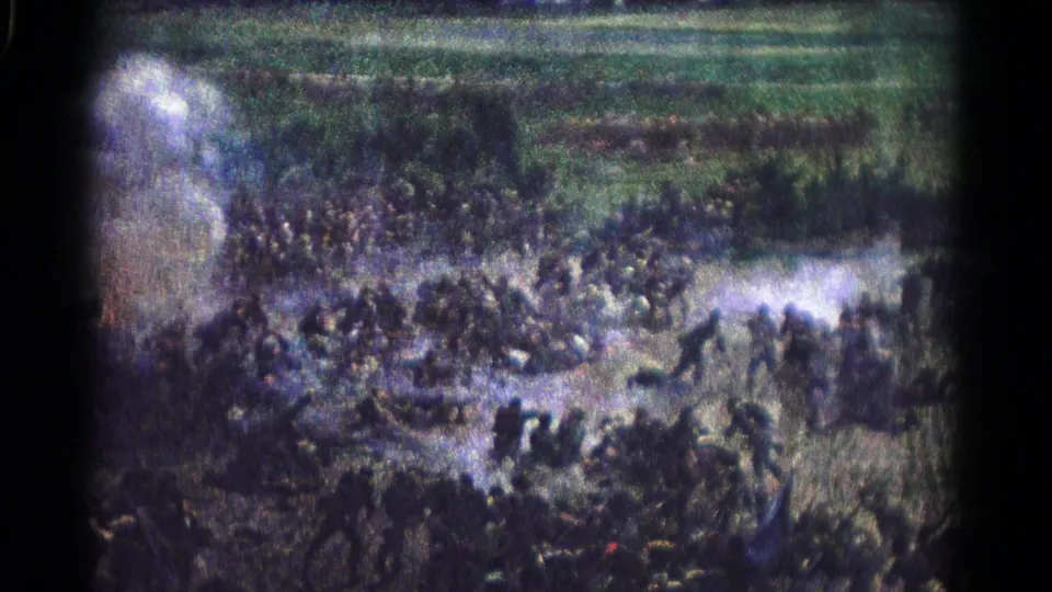 Color 8mm frame from 1966 Hagerstown showing a wide, soft-focus view of people spread across smoky open ground.